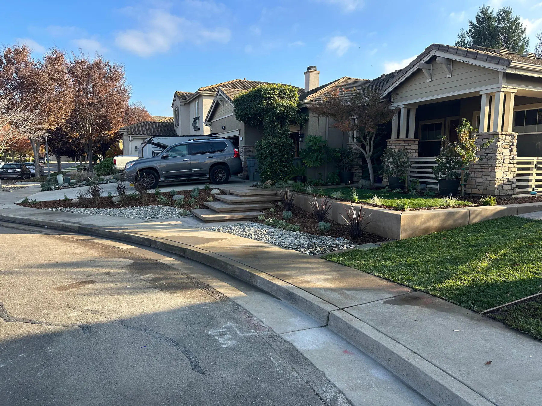 Front yard landscape with concrete, planting, and curb appeal