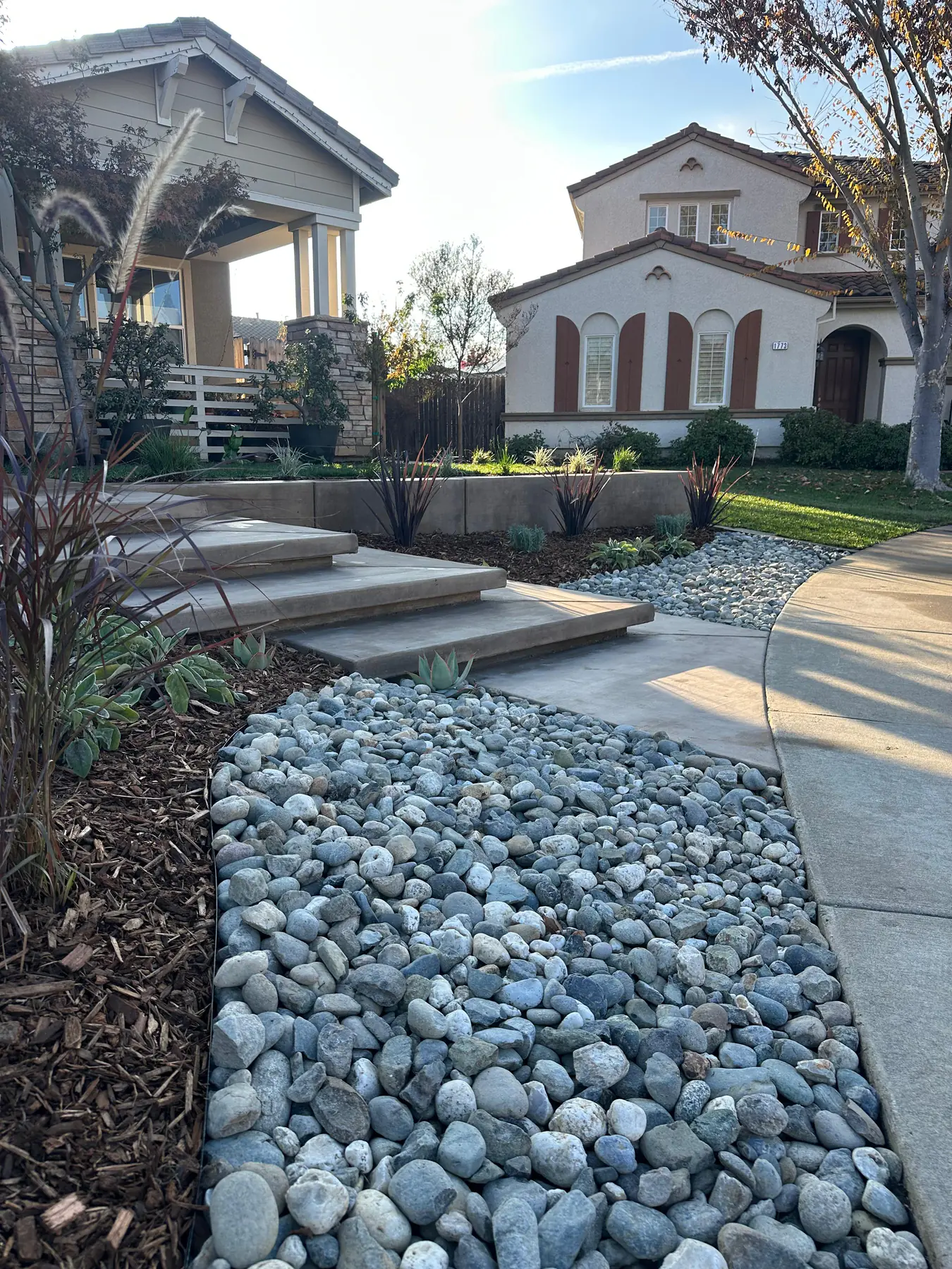 Completed front yard with steps, walls, planting, and lawn
