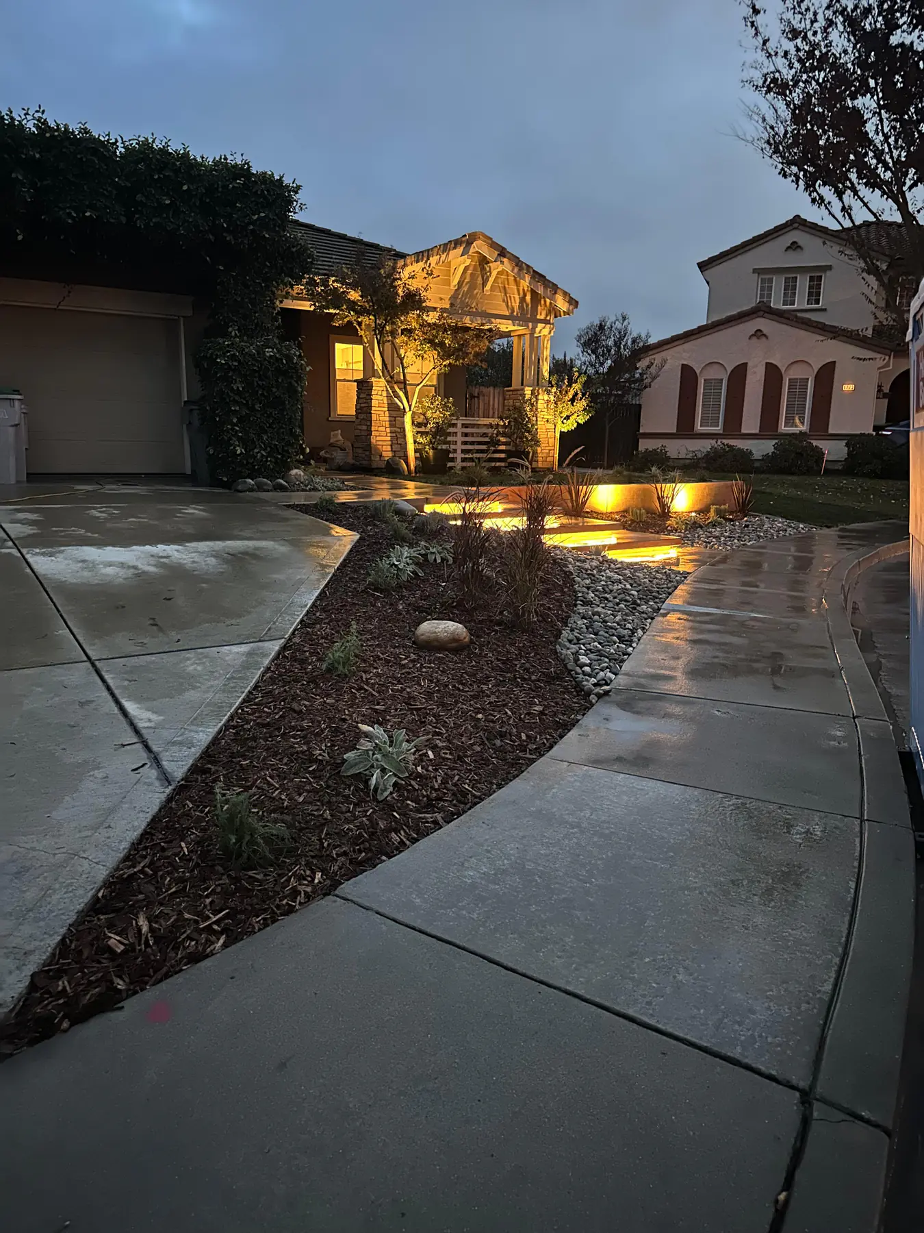 Residential entry landscape lighting at dusk