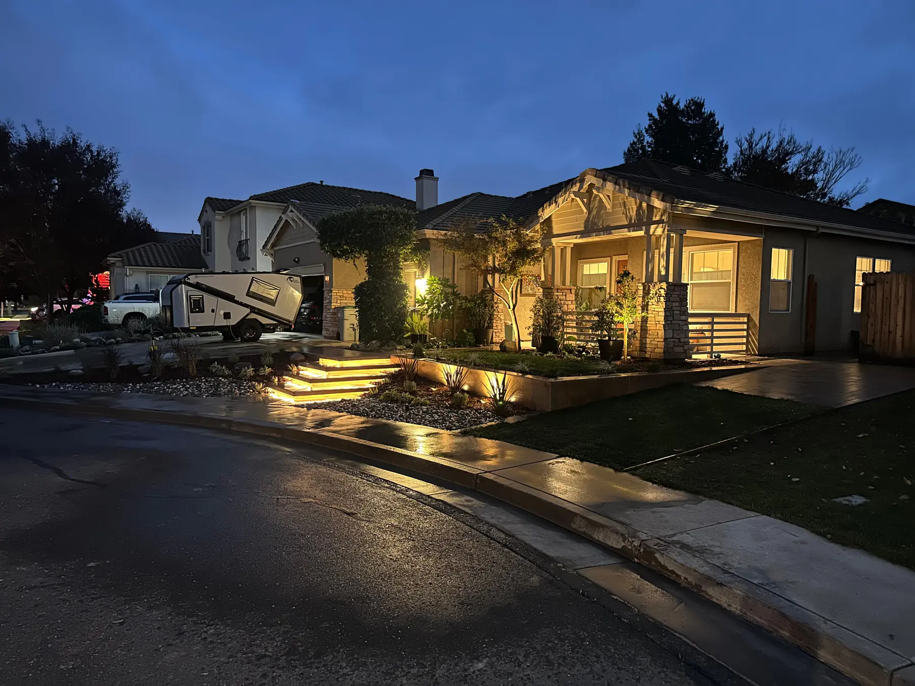 Front yard landscape with path lighting at night