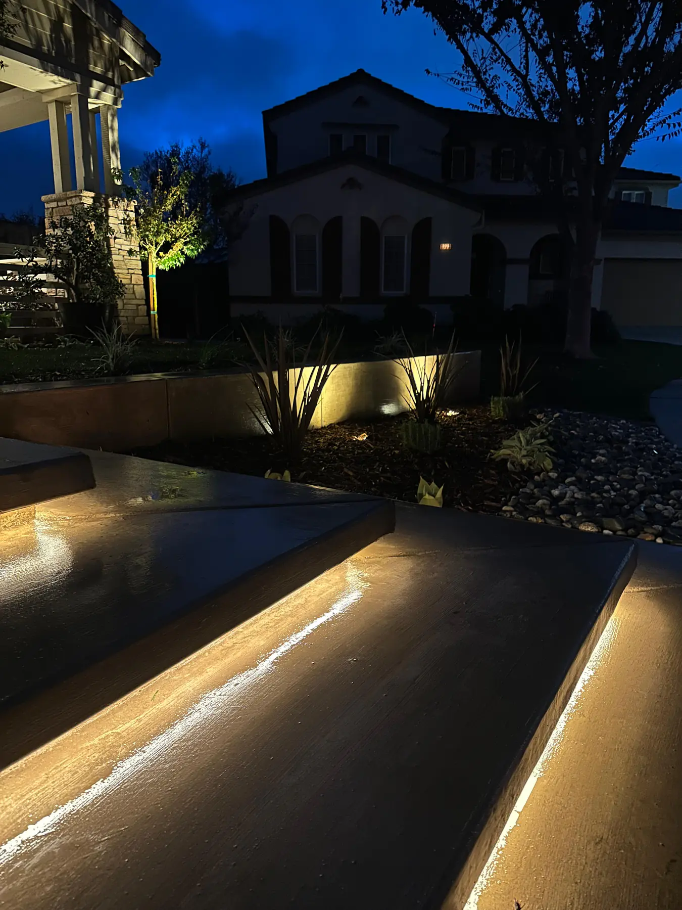 Concrete steps and patio edge illuminated with warm light