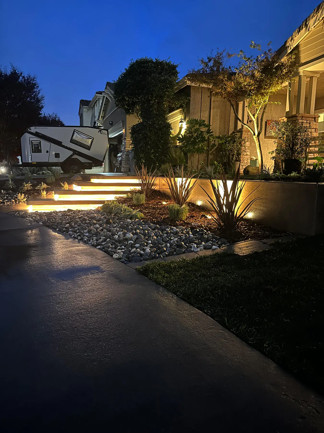 Front landscape bed with lighting and decorative rock