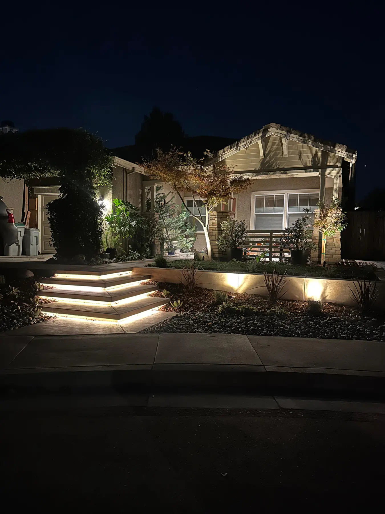 Layered concrete entry steps with warm underlighting