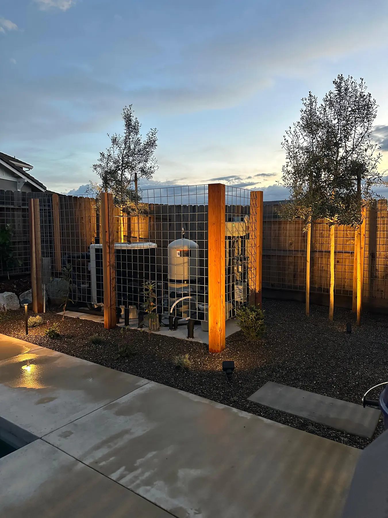 Modern gate and fence lit at dusk