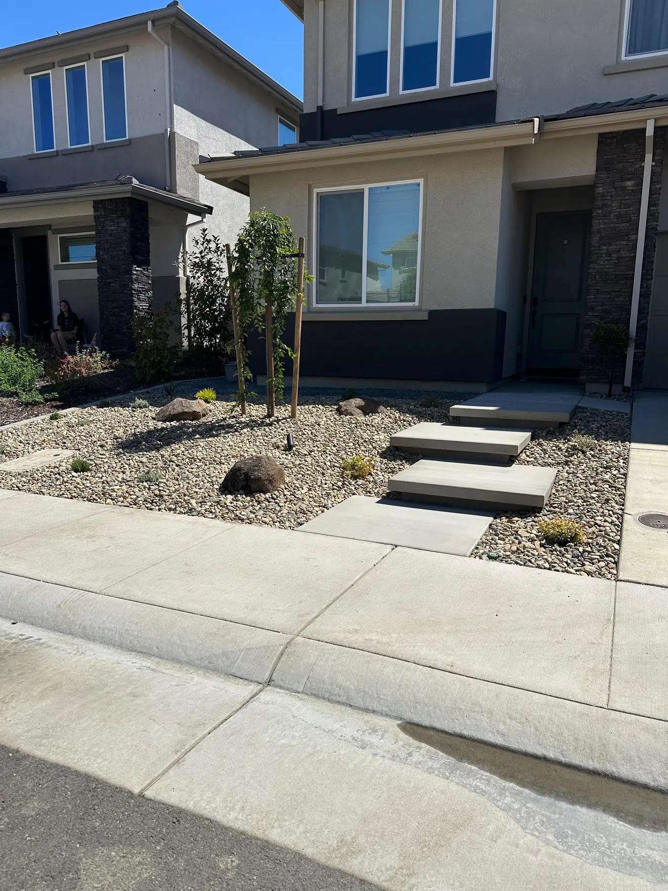 Drought tolerant front yard with concrete and rock